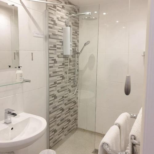 a bathroom with a shower and a sink at Sweet Suites Residence in Lytham St Annes