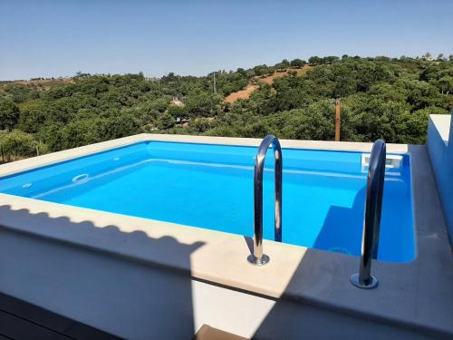 a swimming pool on the roof of a house at Herdade de Vale Maceiras in Santiago do Cacém