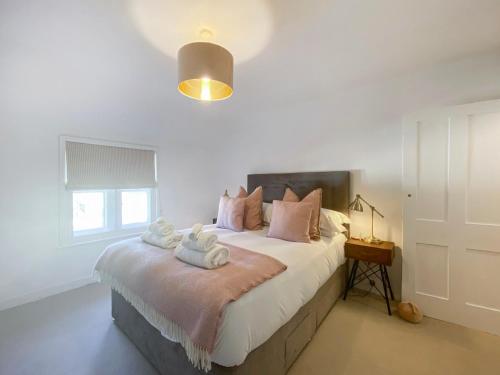a bedroom with a large bed with towels on it at 3 Chestnut Terrace, Long Melford in Long Melford