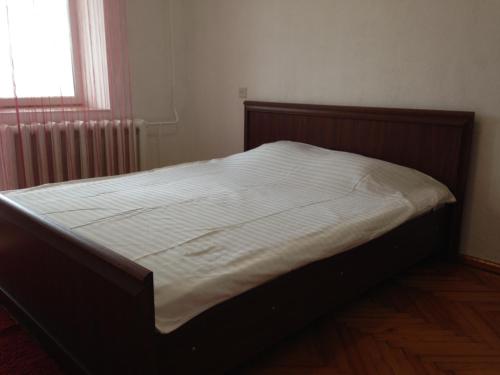 a large bed in a bedroom with a window at Soborna Street 259, three-room apartment in Rivne