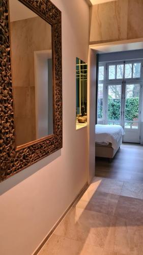 a bedroom with a mirror on the wall and a bed at Short stay Midden Drenthe in Beilen