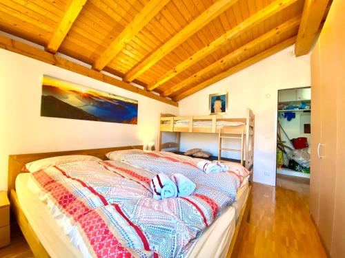 a bedroom with a bed and a wooden ceiling at Comano Lugano Ticino - B&B Walterina in Comano