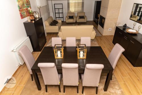 a dining room table and chairs in a living room at Alojamento Local Santa Marta in Zebreira