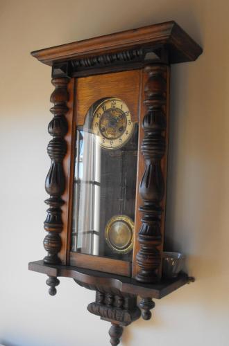 a wooden clock hanging on a wall at Le Sommelet in Somme-Leuze