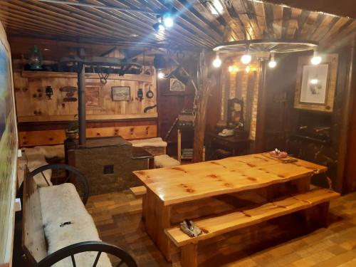 a room with a wooden table and a stove at Pousada Nativa Lages in Lages