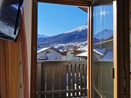 a view from the window of a balcony with mountains at Hotel Garni Schönblick in Sölden