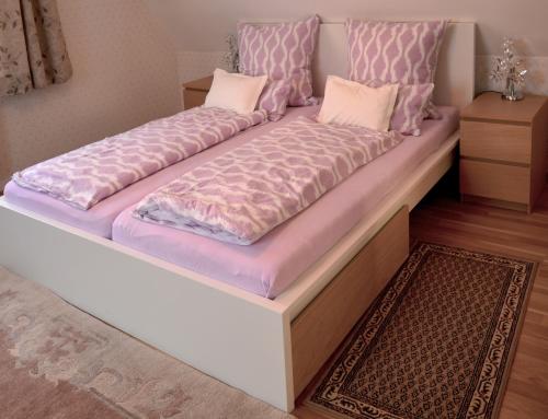 a large bed with two pillows on top of it at Posthotel in Bad Bertrich