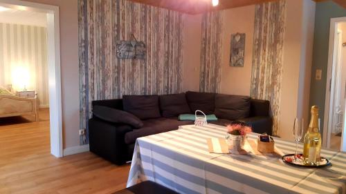 a living room with a couch and a table at Ferienwohnungen-im-Koog-2 in Wesselburenerkoog