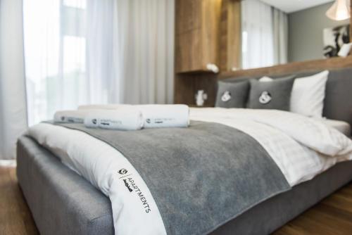 a bed with two pillows on top of it at Central Apartments by Bed&Bath in Kraków