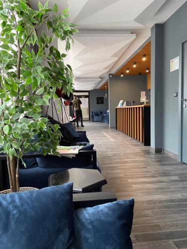 an office lobby with blue pillows and a row of chairs at Brzeće Center Studio Mitrovski Gondola 300m in Kopaonik