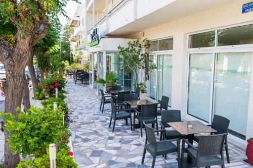 a patio of a restaurant with tables and chairs at Hotel Koala in Kos