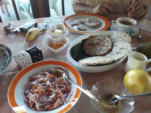 a table with plates of food on top of it at Sea Front Hikkaduwa in Hikkaduwa