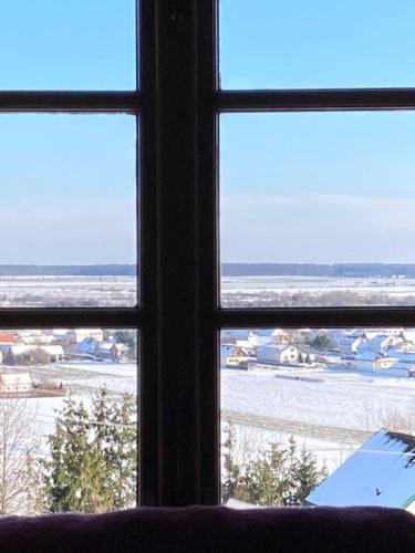 a view from a window of a room with snow at Kellerstöckl Postrumer Weinberg 49 in Kulm im Burgenland