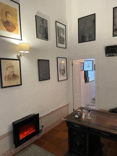 a living room with a fireplace and pictures on the wall at Sintra1012 Boutique Guesthouse in Sintra