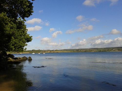 a view of a lake with boats in the water at Gîte des Gardiens de Phare in Lézardrieux