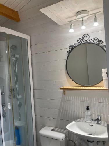 a bathroom with a sink and a mirror and a toilet at Hermoso Bungalow de madera in Seville