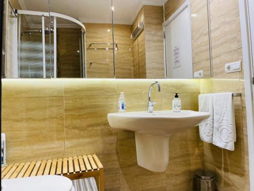 a bathroom with a white sink and a shower at Puerto Denia Harbour Views in Denia
