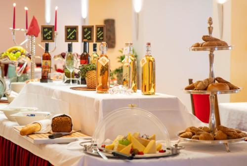 a table with a white table cloth with food on it at Beauty & Wellness Hotel Tirolerhof in Nauders