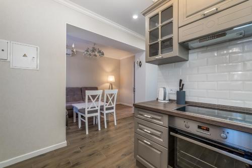 a kitchen with a counter and a dining room at 20 Deribasivska Design Apartment in Odesa