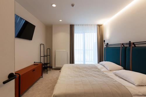 Postel nebo postele na pokoji v ubytování HVOYA Apart-Hotel & SPA