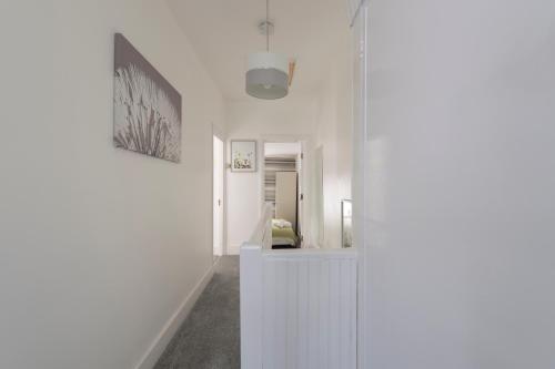 a room with a white wall and a picture on the wall at Fortified Beautiful Three bedroom House in Plumstead