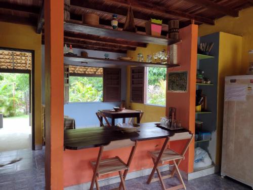 eine Küche mit Tisch und Stühlen in einem Zimmer in der Unterkunft Suite d'Artistes in Imbassai