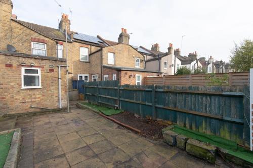 a wooden fence in front of some houses at Fortified Beautiful Three bedroom House in Plumstead