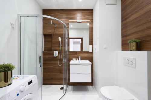 a bathroom with a shower and a sink at Central Apartments by Bed&Bath in Kraków
