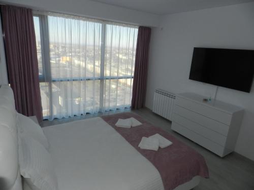 a bedroom with a bed and a large window at AP RELAX Tulcea in Tulcea