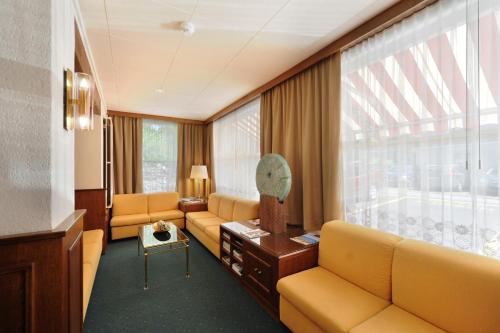 a living room with couches and a large window at Elite in Lausanne