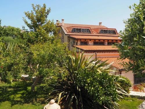 a building with an orange roof and some trees at B&B Al Giardino in Monreale