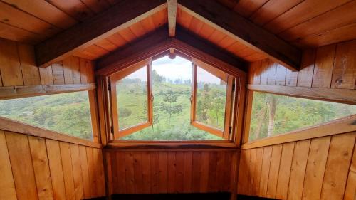 a room with a large window in a wooden house at Finca Chalet La Tawa in Sevilla