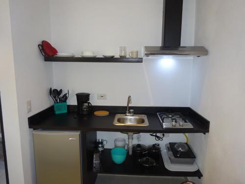 a small kitchen with a sink and a stove at OUR Place 2 in San Andrés