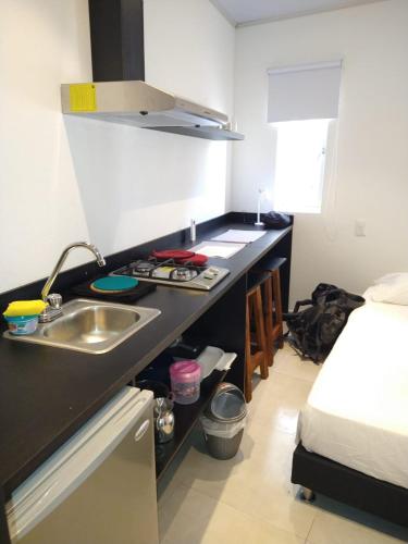 a kitchen with a sink and a bed in a room at OUR Place 2 in San Andrés
