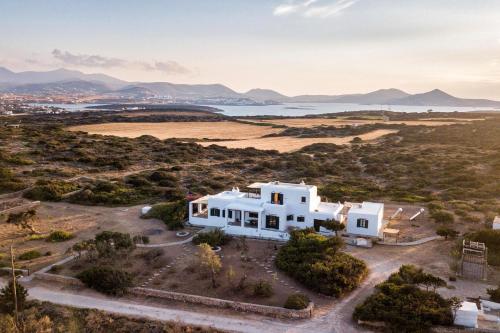 an aerial view of a white house in a field at Traditional Villa 5-min walk to the beach in Santa Maria