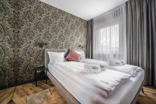 a bedroom with a large bed with white sheets at StoneHill24 - Apartament & Spa in Szklarska Poręba