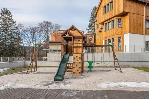 a playground in front of a building at StoneHill24 - Apartament & Spa in Szklarska Poręba