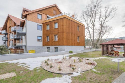 a building with a garden in front of it at StoneHill24 - Apartament & Spa in Szklarska Poręba