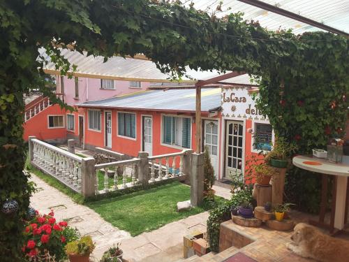 an outside view of a building with a garden at Hostal La Casa del Sol in Copacabana
