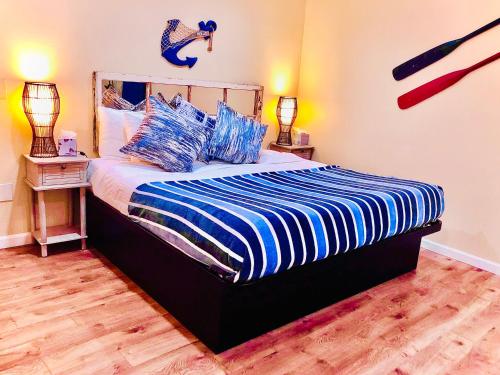 a bedroom with a bed with a blue and white comforter at Captain's Inn at Moss Landing in Moss Landing