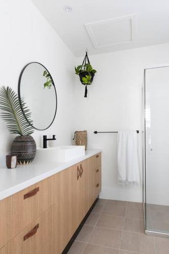 a bathroom with a sink and a mirror at Currumbin Beach House - 120m to the beach in Gold Coast