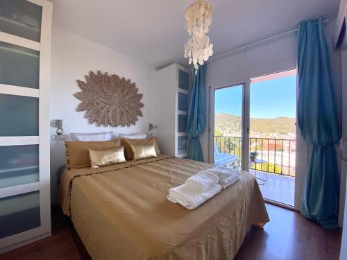 a bedroom with a bed and a large window at Sailor Apartment sea views in Tossa de Mar