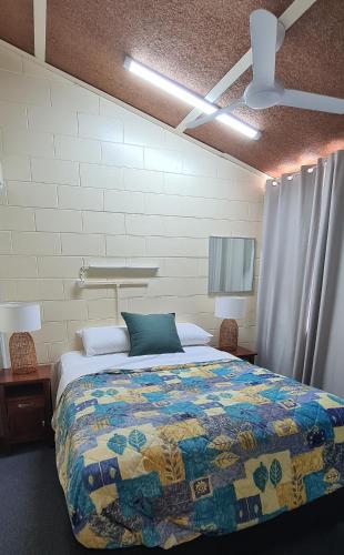 a bedroom with a bed with a quilt on it at Emthree Seaside Apartments in Townsville