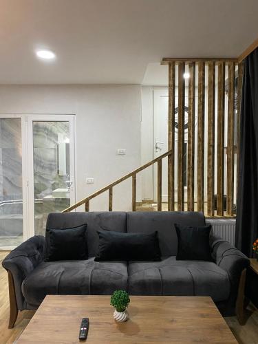 a living room with a couch and a table at Vila Simona in Mavrovo