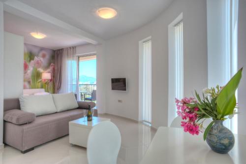 a living room with a couch and a table at Guest House Pržno Bay in Sveti Stefan