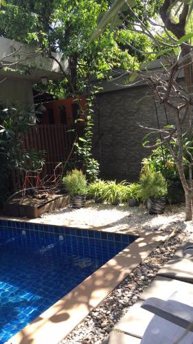 a backyard with a swimming pool and a house at Nature Home in Phra Nakhon Si Ayutthaya