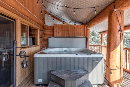a jacuzzi tub on a deck in a cabin at Spirit Lodge at Silverstar in Vernon