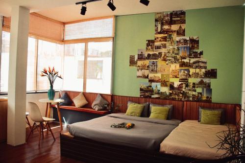 a bedroom with two beds and a wall of pictures at Coucou Homestead I - Homestay & Dorm District 1 in Ho Chi Minh City