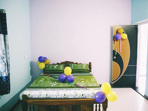 a bedroom with a bed with balloons on it at Hiremane Residency in Sringeri