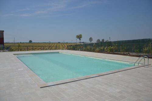 a large swimming pool with blue water at Il Poggio Agrisport in Poirino